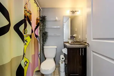 a bathroom with a toilet and a sink at Urban Oasis - Modern 1 bedroom w pool access free parking in Toronto