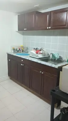 a kitchen with wooden cabinets and a counter top at Two Separate Units in Richmond Hill