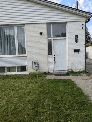 a white brick house with a white door at Two Separate Units in Richmond Hill