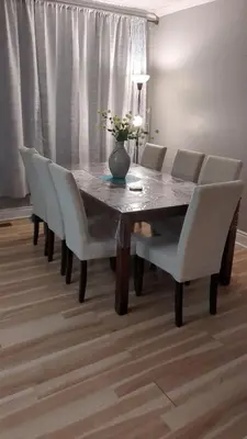 a dining room table with chairs and a vase on it at Two Separate Units in Richmond Hill