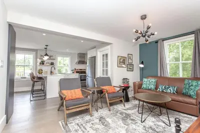 a living room with a couch and a table at Boutique Quality Home Downtown by the Shaw in Niagara on the Lake