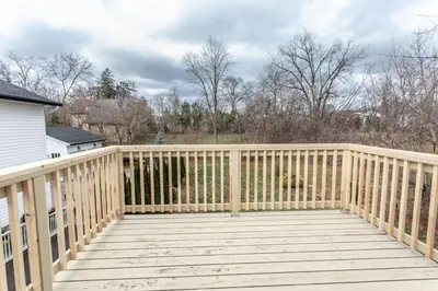 a wooden deck with a wooden fence on a house at Boutique Quality Home Downtown by the Shaw in Niagara on the Lake