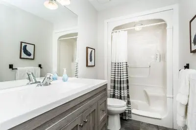 a white bathroom with a sink and a toilet at Boutique Quality in Old Towne with Hot Tub in Niagara on the Lake