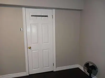 a white closet with a door in a room at Cosy Romantic and Cost Effective Stay in Kitchener in Kitchener