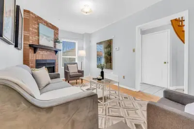 a living room with a couch and a fireplace at Spacious 4BR Home with Parking in Richmond Hill
