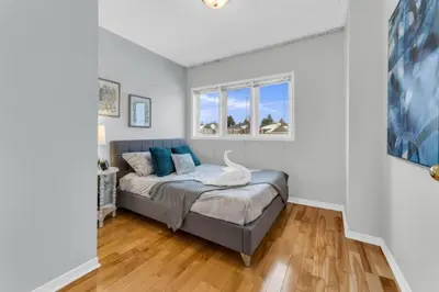 a bedroom with a bed and a window at Spacious 4BR Home with Parking in Richmond Hill