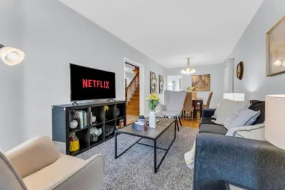 a living room with a couch and a tv at Spacious 4BR Home with Parking in Richmond Hill