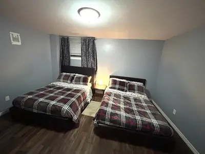 a bedroom with two beds and a window at Deluxe Apartment in Caledon