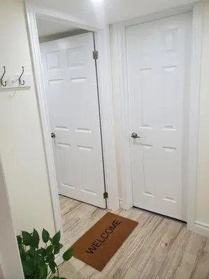 a hallway with two white doors and a welcome mat at Home of Sweet Dream in Whitby