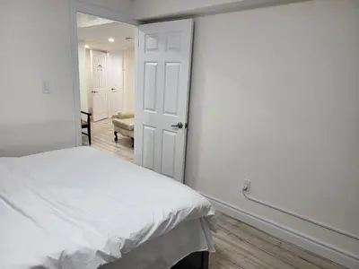 a white bedroom with a bed and a doorway at Home of Sweet Dream in Whitby