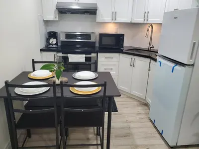 a small kitchen with a black table and a refrigerator at Home of Sweet Dream in Whitby