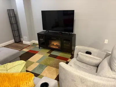 a living room with a fireplace and a television at Bolster in Uxbridge