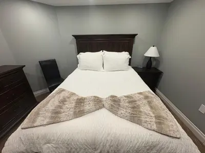 a bedroom with a bed with a blanket on it at Bolster in Uxbridge