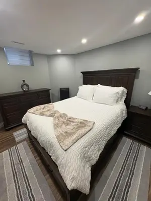 a bedroom with a large bed with white sheets and pillows at Bolster in Uxbridge