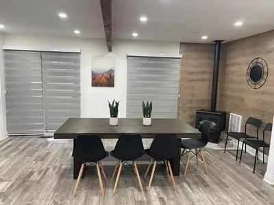 a dining room with a wooden table and chairs at Cottage on Muskoka river in Bracebridge