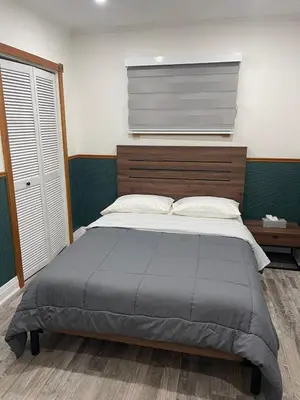 a bedroom with a large bed with a wooden headboard at Cottage on Muskoka river in Bracebridge