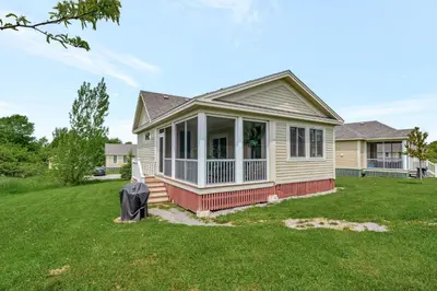 a house with a front porch and a yard at The Finch - 59 Butternut in Cherry Valley