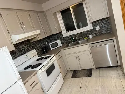 a kitchen with white cabinets and white appliances at Smart Budget Friendly Room-Near Airport, Groceries,College in Kitchener