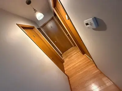 a staircase with a wooden door and a light at Smart Budget Friendly Room-Near Airport, Groceries,College in Kitchener