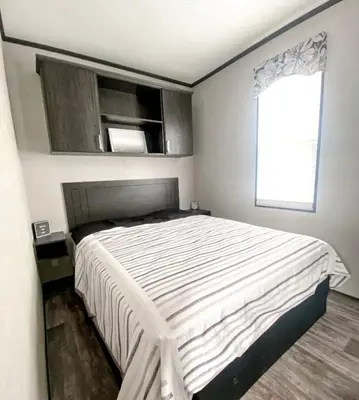 a bedroom with a large white bed with a window at The Balmoral at Duck Lake in Carden