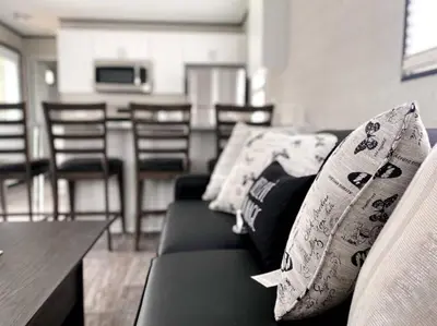 a living room with a couch and a table and chairs at The Balmoral at Duck Lake in Carden