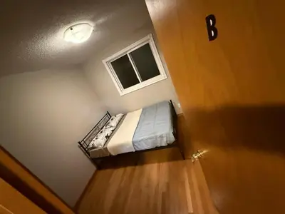 a small bedroom with a bed and a window at UPTOWN WATERLOO-KWC ROOM-Best Location,Lowest Prices in Waterloo