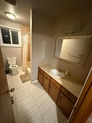 a bathroom with a sink and a toilet and a mirror at UPTOWN WATERLOO-KWC ROOM-Best Location,Lowest Prices in Waterloo