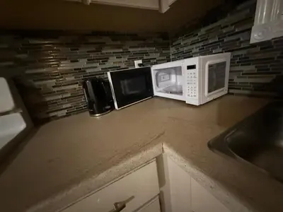 a kitchen counter with a microwave and a sink at UPTOWN WATERLOO-KWC ROOM-Best Location,Lowest Prices in Waterloo