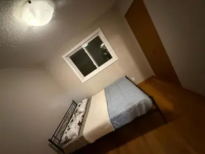 a small bedroom with a bed and a window at UPTOWN WATERLOO-KWC ROOM-Best Location,Lowest Prices in Waterloo
