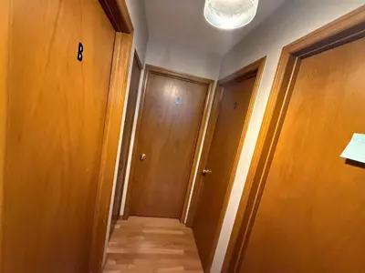 a hallway with wooden doors and a light on the ceiling at UPTOWN WATERLOO-KWC ROOM-Best Location,Lowest Prices in Waterloo
