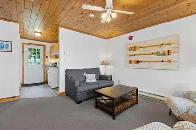 a living room with a couch and a table at Port Cunnington Lodge in Dwight