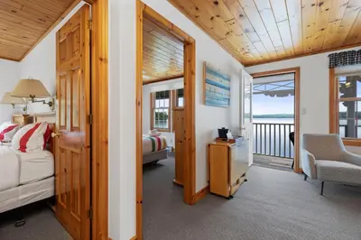 a bedroom with a bed and a balcony at Port Cunnington Lodge in Dwight