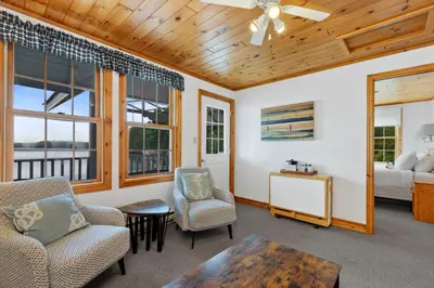 a living room with two chairs and a table at Port Cunnington Lodge in Dwight