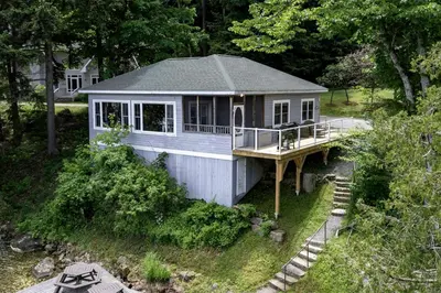 a small house with a porch and a deck at Port Cunnington Lodge in Dwight