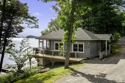 a tiny house on the shore of a lake at Port Cunnington Lodge in Dwight