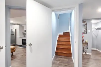 a hallway with a stairway leading to a home at Deluxe Apartment in Caledon