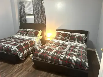 two beds sitting next to each other in a bedroom at Deluxe Apartment in Caledon