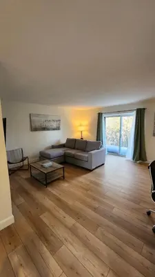 a living room with a couch and a table at ENTIRE 2 BEDROOM APARTMENT by UW RESEARCH PARK - PS5 in Waterloo