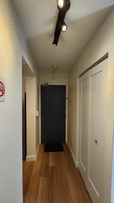 an empty hallway with a black door and a ceiling fan at ENTIRE 2 BEDROOM APARTMENT by UW RESEARCH PARK - PS5 in Waterloo