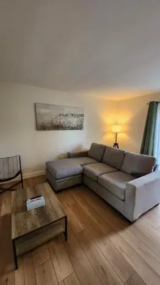 a living room with a couch and a table at ENTIRE 2 BEDROOM APARTMENT by UW RESEARCH PARK - PS5 in Waterloo