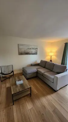 a living room with a couch and a table at ENTIRE 2 BEDROOM APARTMENT by UW RESEARCH PARK - PS5 in Waterloo