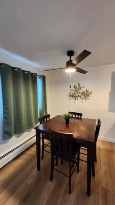 a dining room table with chairs and a ceiling fan at ENTIRE 2 BEDROOM APARTMENT by UW RESEARCH PARK - PS5 in Waterloo