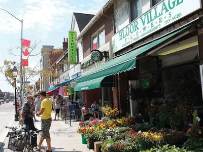 a group of people standing outside of a flower shop at Excellent Private Suite in Bloor West Village in Toronto