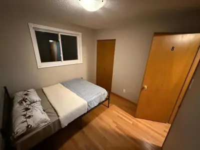 a small bedroom with a bed and a window at HEAVY PRICE CUT-BOOK NOW!- Next to Airport, Downtown,Transit in Kitchener