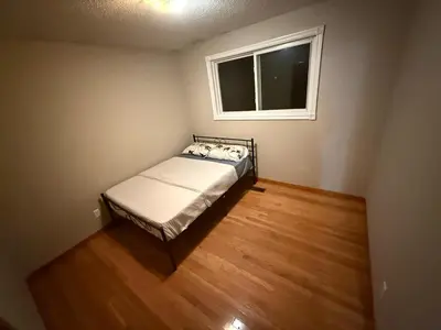 a small bedroom with a bed and a window at HEAVY PRICE CUT-BOOK NOW!- Next to Airport, Downtown,Transit in Kitchener