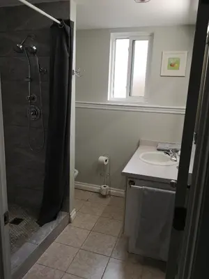 a bathroom with a shower and a sink at Cozy Apartment Unit in London