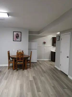 a dining room and kitchen with a table and chairs at Cozy Apartment Unit in London