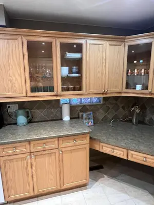 a kitchen with wooden cabinets and a counter top at HOMESTAY NEXT TO SQUARE ONE MALL- 5 Mins Airport-24 HRS CHECKIN-MAJOR COST CUT in Mississauga
