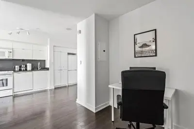 a white kitchen with a desk and a black chair at Elegant Condo, Toronto Views , CityPlace Downtown in Toronto