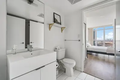 a white bathroom with a toilet and a sink at Elegant Condo, Toronto Views , CityPlace Downtown in Toronto